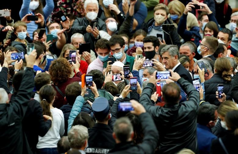Faithful take pictures of Pope Francis during the 