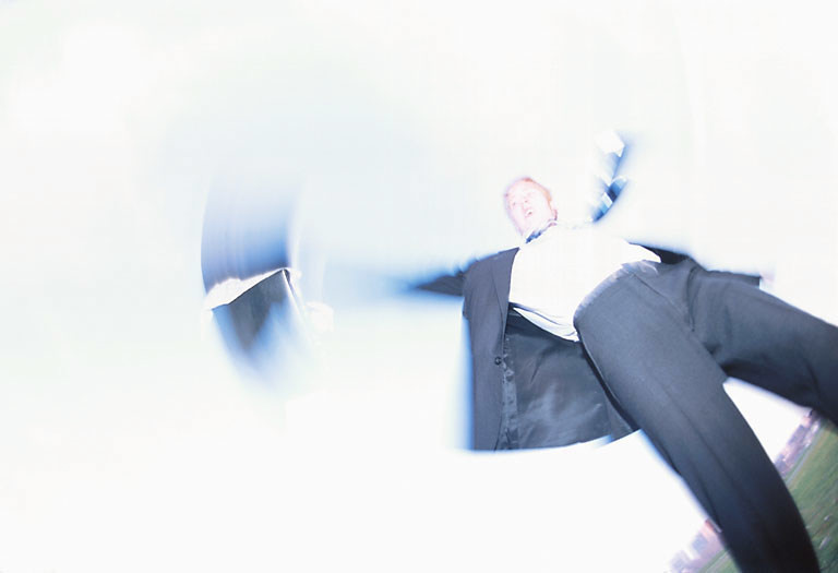 Blur of businessman throwing briefcase.jpg