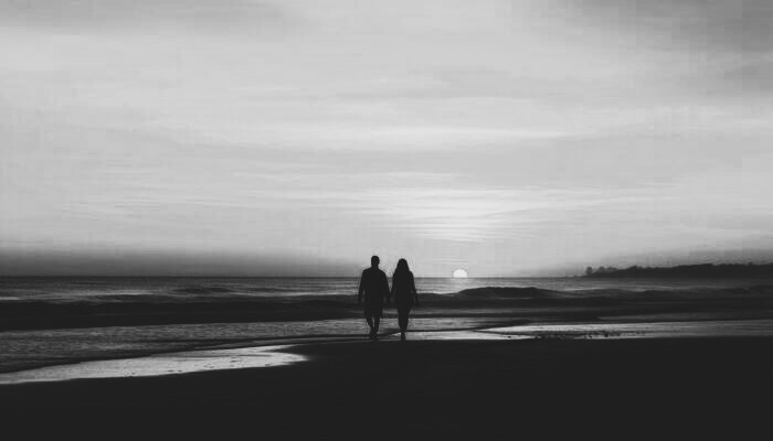 two-people-in-love-walking-on-beach-generated-by-a