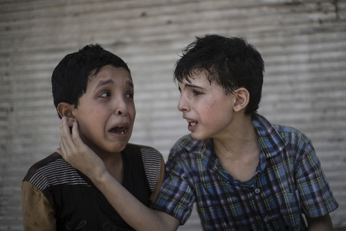 Zeid Ali, 12, left, and Hodayfa Ali, 11, comfort e