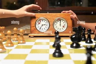 close-up-of-chess-pieces-with-a-chess-clock-on-a-c