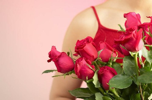 Woman holding red roses 1.jpg