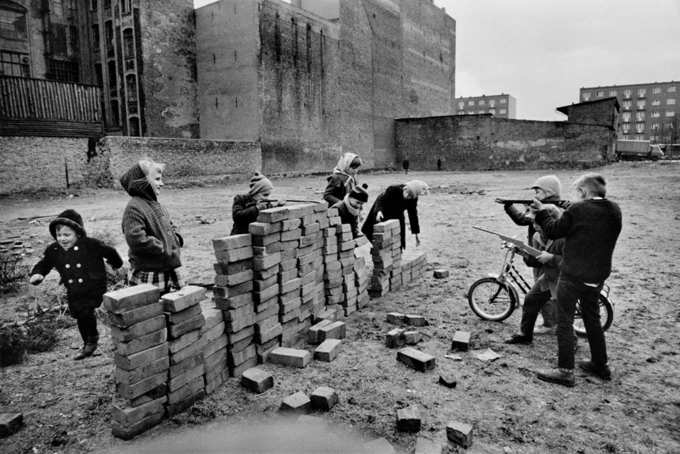 Children pretending to build a wall in West Berlin