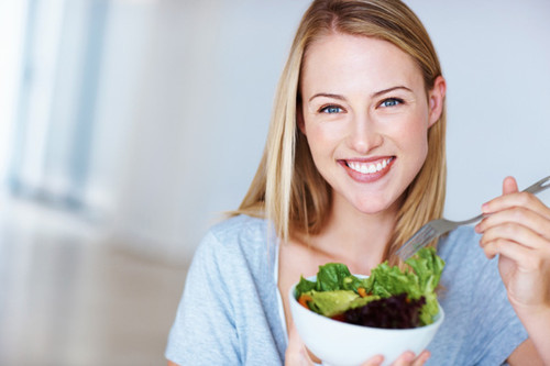 happy-woman-eating-salad-600.jpg