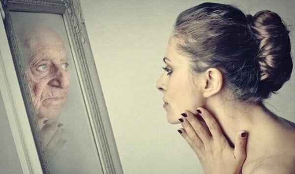 Woman-looking-at-mirror-representing-Dorian-Gray-s