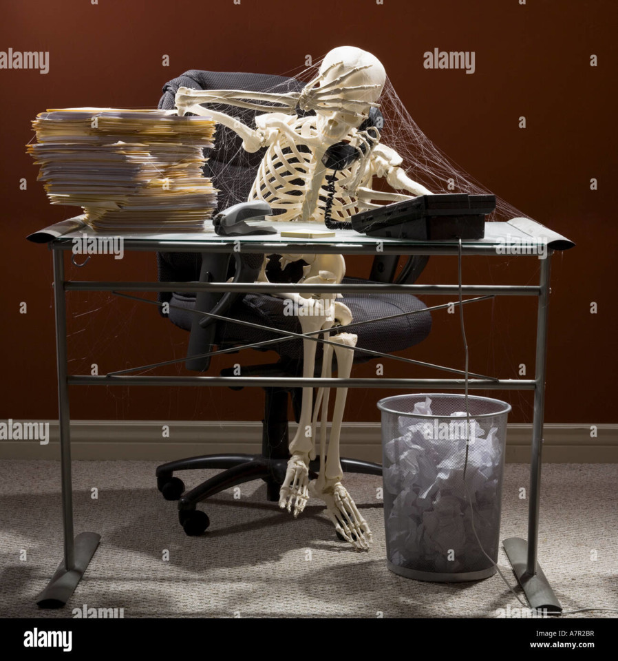 skeleton-sitting-at-desk-talking-on-telephone-with