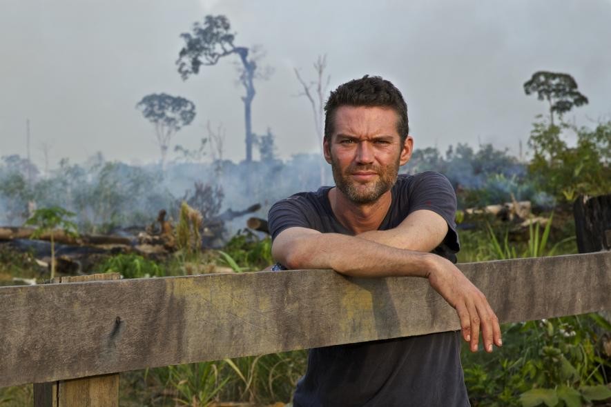 Charlie Hamilton James in burning rainforest. Acre