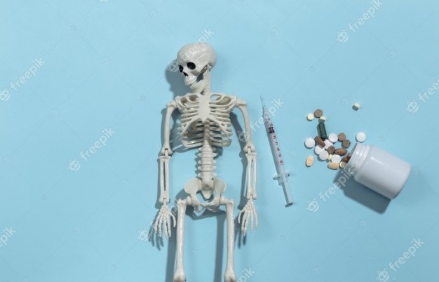 skeleton-syringe-pills-bottle-blue-bright-backgrou