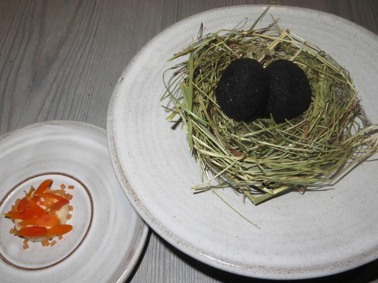 A small egg coated in ash, sauce made from dried trout and pickled marigold