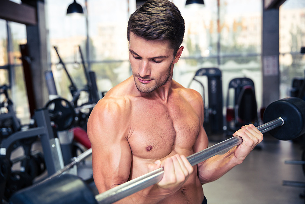 portrait-of-a-muscular-man-doing-exercises-with-ba