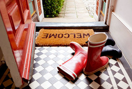getty_rf_photo_of_boots_next_to_welcome_mat.jpg